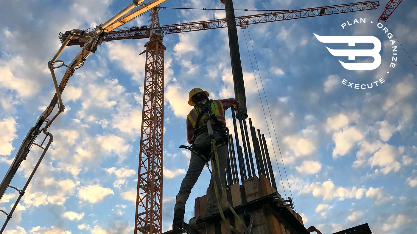 construction worker pouring concrete from crane